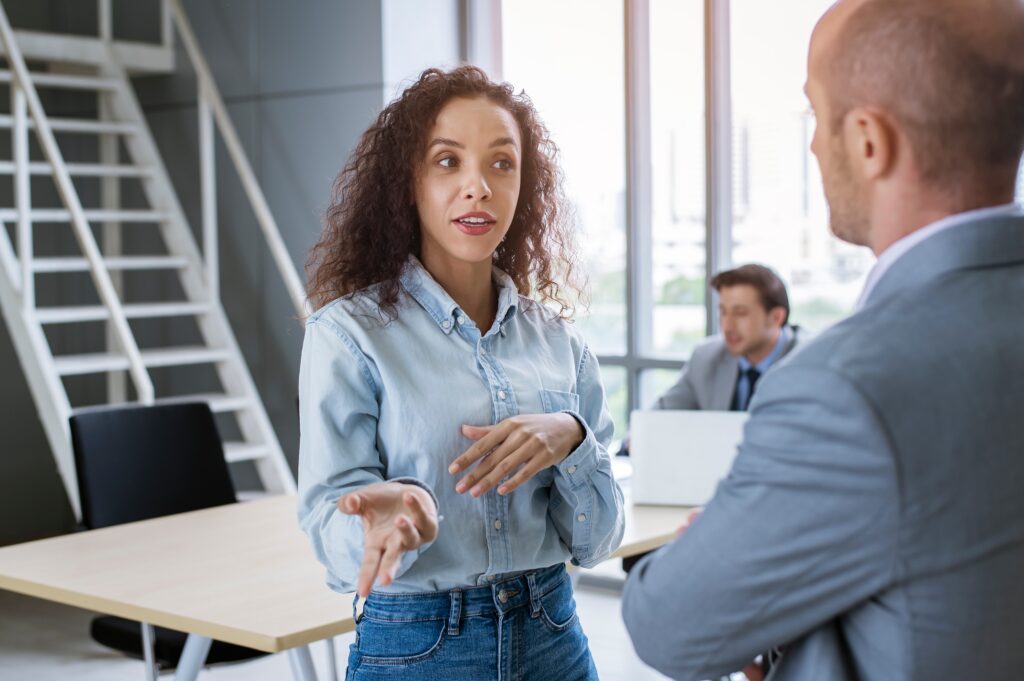 professional woman talking to a man in a suit