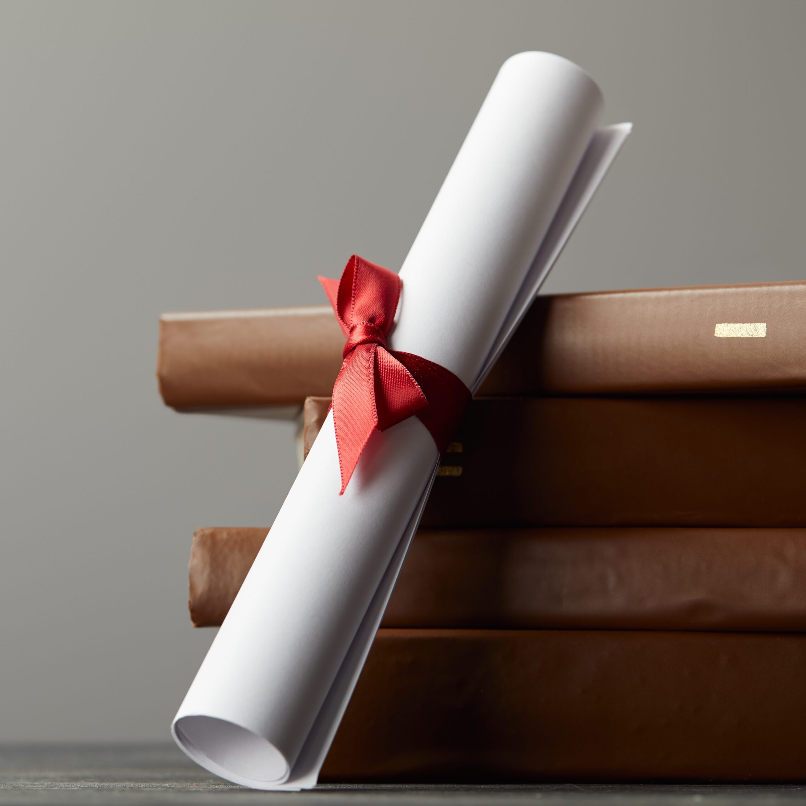 a certificate scroll next to some books